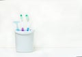 Toothbrushes and tooth accessory in white mug Royalty Free Stock Photo