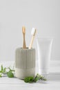 Toothbrushes, toothpaste and herbs on white wooden table Royalty Free Stock Photo