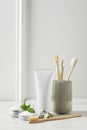 Toothbrushes, toothpaste and herbs on white wooden table Royalty Free Stock Photo