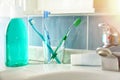 Toothbrushes toothpaste and mouthwash on a sink general view Royalty Free Stock Photo