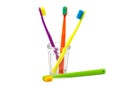 Toothbrushes in a transparent glass on a white background