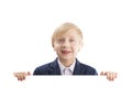 Toothless blond schoolboy holds a large white placard. Boy with a billboard. Place for your text. Empty place