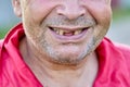 Toothless smile of an elderly unshaven man from Eastern Europe. Royalty Free Stock Photo