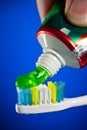 Toothpaste being squeezed onto a toothbrush Royalty Free Stock Photo