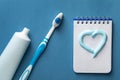 Toothpaste with brush and notebook with heart Royalty Free Stock Photo
