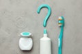 Toothpaste in the form of a question mark and toothbrushes and dental floss. Concept of how to choose the right toothbrush or how