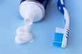 Toothpaste squeezed out from tube on blue background. Dental hygiene concept. Royalty Free Stock Photo