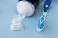 Toothpaste squeezed out from tube and toothbrush on blue background. Dental hygiene concept. Royalty Free Stock Photo