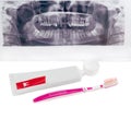 Toothpaste and toothbrush on background dental panoramic radiograph