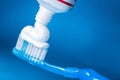 Toothpaste on a toothbrush close-up on background