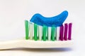 Toothpaste on a toothbrush close-up on a white light background Royalty Free Stock Photo