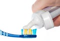 Toothpaste on a toothbrush on a white or colored background Royalty Free Stock Photo