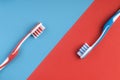 Toothpaste and toothbrushes on red and blue Royalty Free Stock Photo