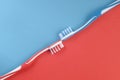 Toothpaste and toothbrushes on red and blue Royalty Free Stock Photo