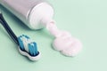 Toothpaste in tube and toothbrush on blue background. Dental hygiene concept Royalty Free Stock Photo