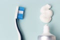 Toothpaste in tube and toothbrush on blue background. Dental hygiene concept Royalty Free Stock Photo