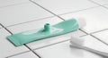 Toothpaste Tube and Toothbrush on White Tiled Surface Royalty Free Stock Photo