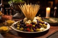 toothpick pile near a plate full of olive and cheese appetizers