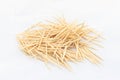 A toothpick is a small thin stick of wood with pointed ends to insert between teeth to remove detritus, usually after a meal