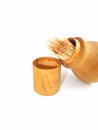 Toothpicks inside wooden holder isolated on a white background