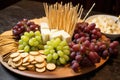 toothpicks pile next to a cheese and grapes platter