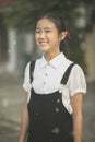 toothy smiling face of asian teenager wearing white and black suit standing outdoor Royalty Free Stock Photo