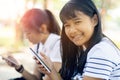 Toothy smiling face of cheerful asian teenager holding smart phone in hand Royalty Free Stock Photo