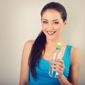 Toothy smiling happy beautiful woman holding the bottle of pure Royalty Free Stock Photo