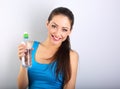 Toothy smiling happy beautiful woman holding the bottle of pure Royalty Free Stock Photo