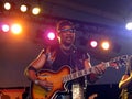 Toots plays guitar during set on stag Royalty Free Stock Photo