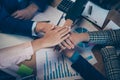 Top above high angle cropped close-up view of staff putting palms on each other over desktop desk table charts diagram