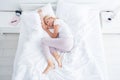 Top above high angle view of her she nice attractive dreamy cheery sweet aged woman lying in bed sleeping spending day Royalty Free Stock Photo