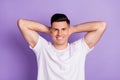 Top above high angle view photo of young man happy positive smile hands behind head rest relax isolated over purple Royalty Free Stock Photo