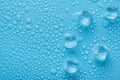 Top above overhead close up macro view photo of ice cubes and water drops on blue background with copy empty blank space Royalty Free Stock Photo