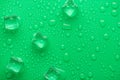 Top above overhead close up view photo of ice cubes on bright vibrant color background with drops Royalty Free Stock Photo