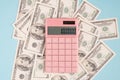 Top above overhead close up view photo of pink calculator lie on desktop table on pile stack of money isolated over pastel color Royalty Free Stock Photo