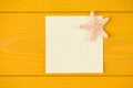 Top above overhead view close-up photo of blank note and starfish isolated on yellow wooden background with copyspace Royalty Free Stock Photo