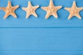 Top above overhead view close-up photo of starfish row on top isolated on blue wooden background with copyspace Royalty Free Stock Photo