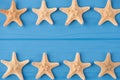 Top above overhead view close-up photo of starfish rows isolated on blue wooden background with copyspace Royalty Free Stock Photo