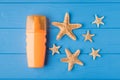 Top above overhead view close-up photo of sunscreen and starfish isolated on blue wooden background with copyspace Royalty Free Stock Photo