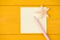 Top above overhead view cropped photo of blank note pencil and starfish isolated on yellow wooden background with copyspace Royalty Free Stock Photo