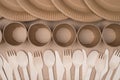 Top above overhead view photo of rows of wooden cutlery, paper cup and plates isolated on craft paper background table