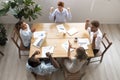 Top above view happy multi-ethnic coworkers scream, applaud, celebrating win