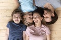 Top above view joyful family lying on heated warm floor. Royalty Free Stock Photo