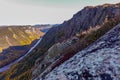 View from top of a tundra looking at colorful smaller mountains peaks