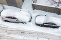 Top aerail view of apartment office building parking lot with many cars covered by snow stucked after heavy blizzard snowfall Royalty Free Stock Photo