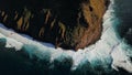 Top aerial of Molokai island and Kalaupapa cliffs against sunny and cloudy sky in the background