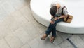 Top aerial person uses mobile phone and sits in white bench