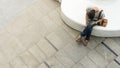 Top aerial person uses mobile phone and sits in white bench