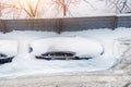 Top aerial view of apartment office building parking lot with many cars covered by snow stucked after heavy blizzard snowfall Royalty Free Stock Photo